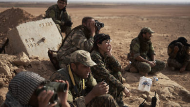 Rojda Felat surveys a flank of Tal al-Samam with other SDF commanders