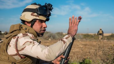 Iraqi Army soldier signals for others to move forward