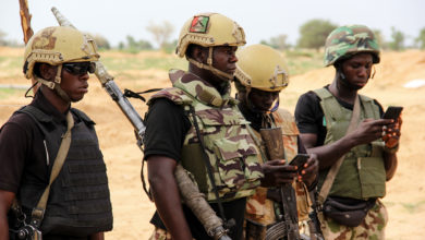 Nigerian army soldiers stand at a base
