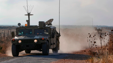 An Israeli military vehicle patrols near the Syrian border in the Israeli-annexed Golan Heights on Aug. 3, near the location where the army said it killed four men placing explosives at a security fence.