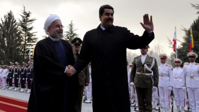 Iranian President Hassan Rouhani (left) shakes hands with Venezuelan President Nicolas Maduro after reviewing the honor guard at the Saadabad Palace in Tehran on January 10, 2015