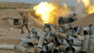Photo of a Karabakh gunner firing an artillery piece towards Azeri positions.