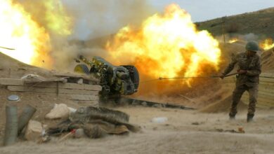 A serviceman of Karabakh's Defence Army fires an artillery piece towards Azeri positions during the ongoing fighting over the breakaway Nagorno-Karabakh region on October 4, 2020