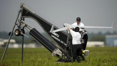two men with Insitu ScanEagle drone