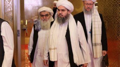 Members of the Taliban delegation arrive for peace talks between the Afghan government and the Taliban in Doha, Qatar on Sunday