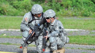 A US Army Master Sergeant provides guidance to a Pvt. during a field training exercise.