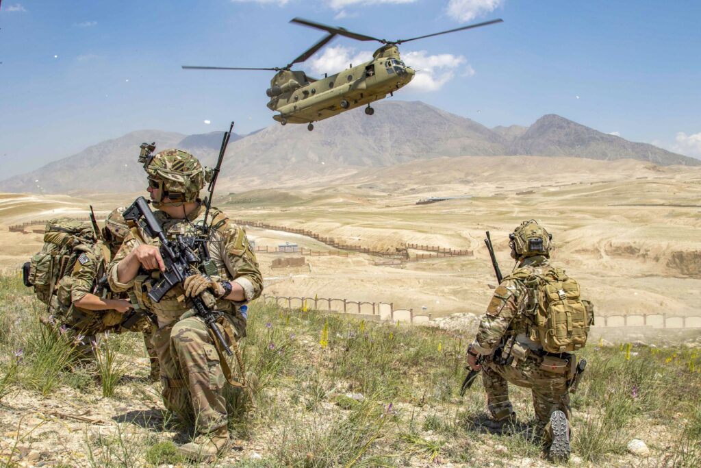 Soldiers from 1st Battalion, 121st Infantry Regiment of the 48th Infantry Brigade Combat Team provide security as a CH-47 Chinook helicopter lands after a key leader engagement in Southeastern Afghanistan