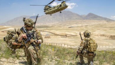 Soldiers from 1st Battalion, 121st Infantry Regiment of the 48th Infantry Brigade Combat Team provide security as a CH-47 Chinook helicopter lands after a key leader engagement in Southeastern Afghanistan