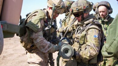 American soldier shows soldier from the Finnish Army an AT-4 anti-armor weapon