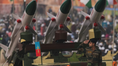 Soldier salutes next to an Akash missile system
