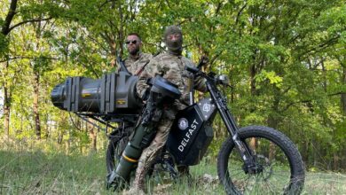 Ukrainian soldiers on a stealthy electric bike modified to carry next-generation light anti-tank weapons