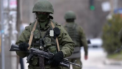 Russian soldiers patrol outside the navy headquarters in Simferopol, Crimea