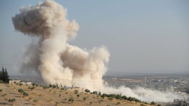 Smoke billowing above buildings during a reported airstrike by pro-regime forces on Khan Sheikhun in the south of the northwestern Syrian province of Idlib, Syria