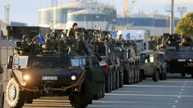 Members of German Bundeswehr 41st Mechanized Infantry Brigade Forward Command Element, 1st Panzer Division is unloaded military vehicles as they arrive at the seaport of Klaipeda, Lithuania