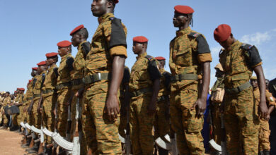Burkinabe soldiers stand in line