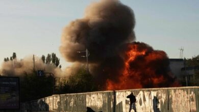 A man falls to the ground following a drone attack in Kyiv