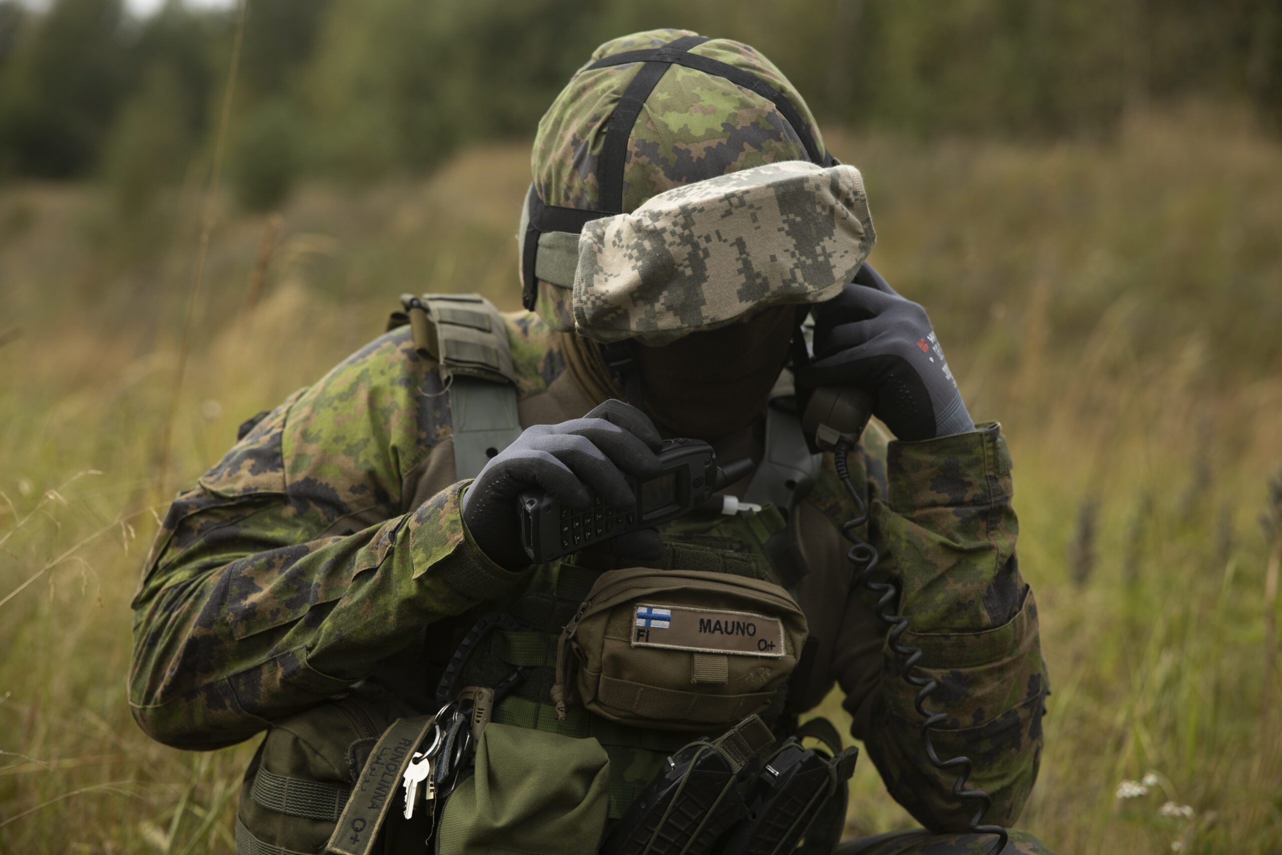 A Finnish Defence Force solider communicating with a radio.