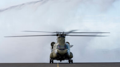 An Australian Army CH-47F Chinook helicopter from the 5th Aviation Regiment taxis through a water arch to celebrate Boeing Aircrewman Instructor, Andrew Fieldhouse as he completes a final flight in the CH-47 Chinook at RAAF Base Townsville, Queensland. *** Local Caption *** On 29 June 2022, before his retirement former Australian Army and now Boeing Aircrewman Instructor, Andrew Fieldhouse took one last flight in a 5th Aviation Regiment Chinook helicopter. In recognition of his years of service, the Townsville Airfield Rescue and Fire Fighting team provided a Water Arch Salute where he was greeted by well-wishers to mark the final flight. Andrew Fieldhouse served a total of 40 years of which 30 were served with the Army Aviation capability.