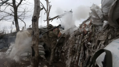 A Ukrainian serviceman fires an RPG towards a Russian position in Donetsk