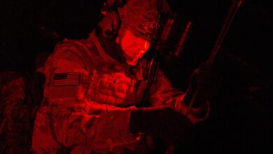 Tactical air control party personnel setting field radio antenna