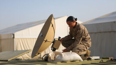 U.S. Marine Corps Lance Cpl. Yerika Zayasbonilla, a data systems administrator with Combat Logistics Regiment 1, 1st Marine Logistics Group, adjusts the satellite on the Marine Corps Wideband Satellite Communications - Expeditionary during exercise Native Fury 22 at a Logistics Support Area established in the Kingdom of Saudi Arabia, Aug. 21, 2022. Native Fury 22 is a biennial exercise focused on the demonstration of the rapid offload and integration of a Maritime Prepositioned Force in the U.S. Central Command area of responsibility in support of regional security, crisis response, and contingency operations. (U.S. Marine Corps photo by Sgt. Alize Sotelo)