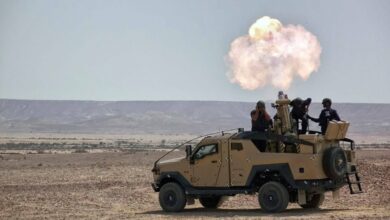 Live firing of 120-mm mortar mounted on armored vehicle.