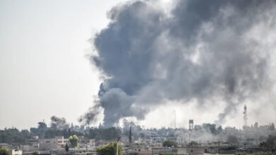 Smoke billows from a fire inside Syria during bombardment by Turkish forces