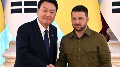 South Korean President Yoon Suk Yeol and his Ukrainian counterpart Volodymyr Zelensky shake hands following talks in Kyiv