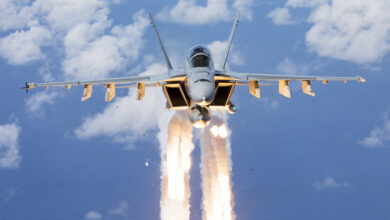 Royal Australian Air Force F/A-18F Super Hornet A44-216 from No. 1 Squadron deploys flares while conducting air-to-air formation flying off the coast of South East Queensland. *** Local Caption *** On 07 December 2021, No. 6, No. 1 and No. 36 Squadrons from RAAF Base Amberley conducted a formation flying activity with EA-18G Growlers, F/A-18F Super Hornets and a C-17A Globemaster III Aircraft off the coast of South East Queensland.
