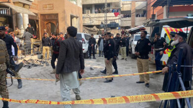 Security personnel cordon off the site of a mosque blast inside the provincial police headquarters in Peshawar