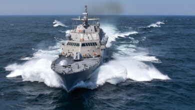 USS Detroit (LCS-7), a littoral combat ship of the US Navy, is seen sailing the waters. Sea mists are seen spraying from its sides as it moves on the water.