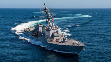 USS Jack H Lucas (DDG-125), the US Navy's first Flight III variant Arleigh Burke-class destroyer, is seen sailing the waters. A plain blue sky serves as the background.