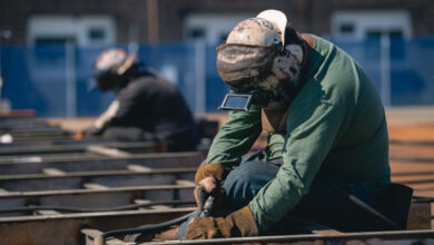A welder works on a steel panel at the Newport News Shipbuilding Norfolk Campus