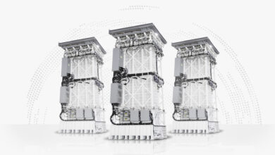 Three MK 41 Vertical Launch Systems are on display. The capability is a tall, tower-shaped equipment with supportive beams and wires fitted onto it. Most of its body is painted white.
