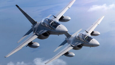 Two fighter planes fly above the clouds.