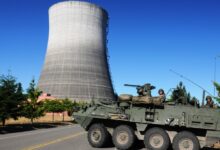 M1135 Reconnaissance Vehicle team conducting hazardous response drill at a nuclear power plant area.
