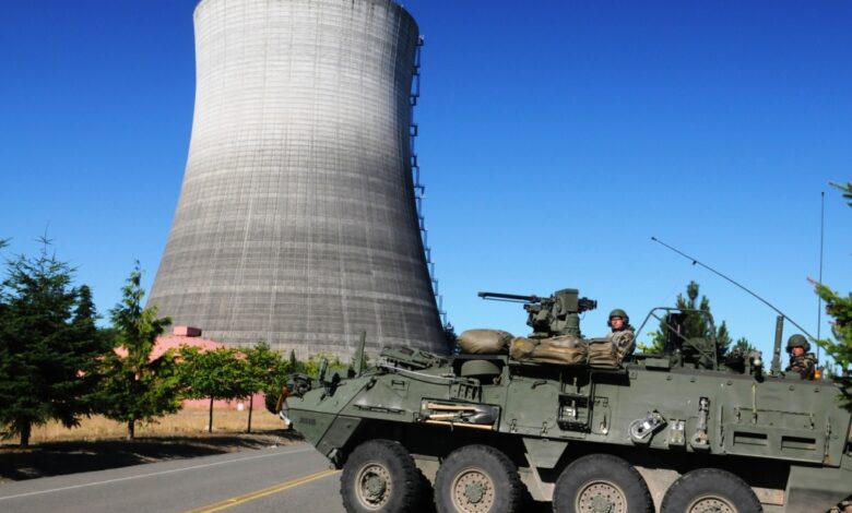 M1135 Reconnaissance Vehicle team conducting hazardous response drill at a nuclear power plant area.