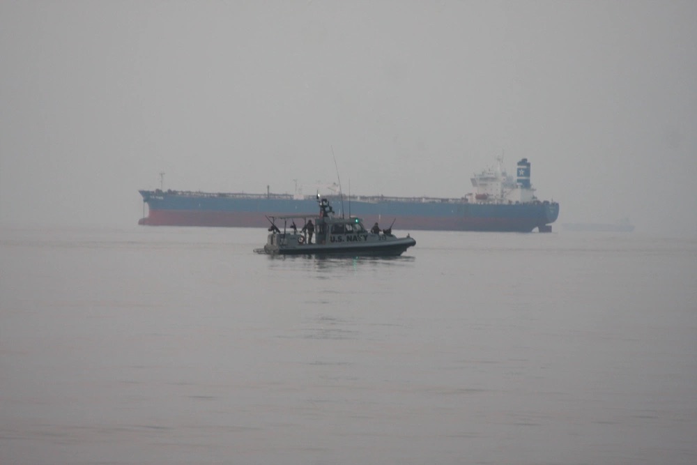 Marines assigned to Fleet Anti-Terrorism Security Team, Central Command (FASTCENT), approach the Arc Liberty, a Military Sealift Command time chartered vessel, in the Arabian Gulf to provide embarked security during a Strait of Hormuz transit.