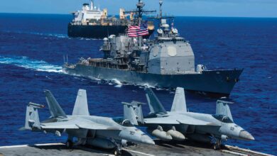 The Ticonderoga-class missile cruiser USS Chancellorsville (CG 62) and USNS 2nd Lt. John P. Bobo (T-AK 3008) steam alongside the Navy’s forward deployed aircraft carrier USS Ronald Reagan (CVN 76) during a photo exercise for Valiant Shield 2018