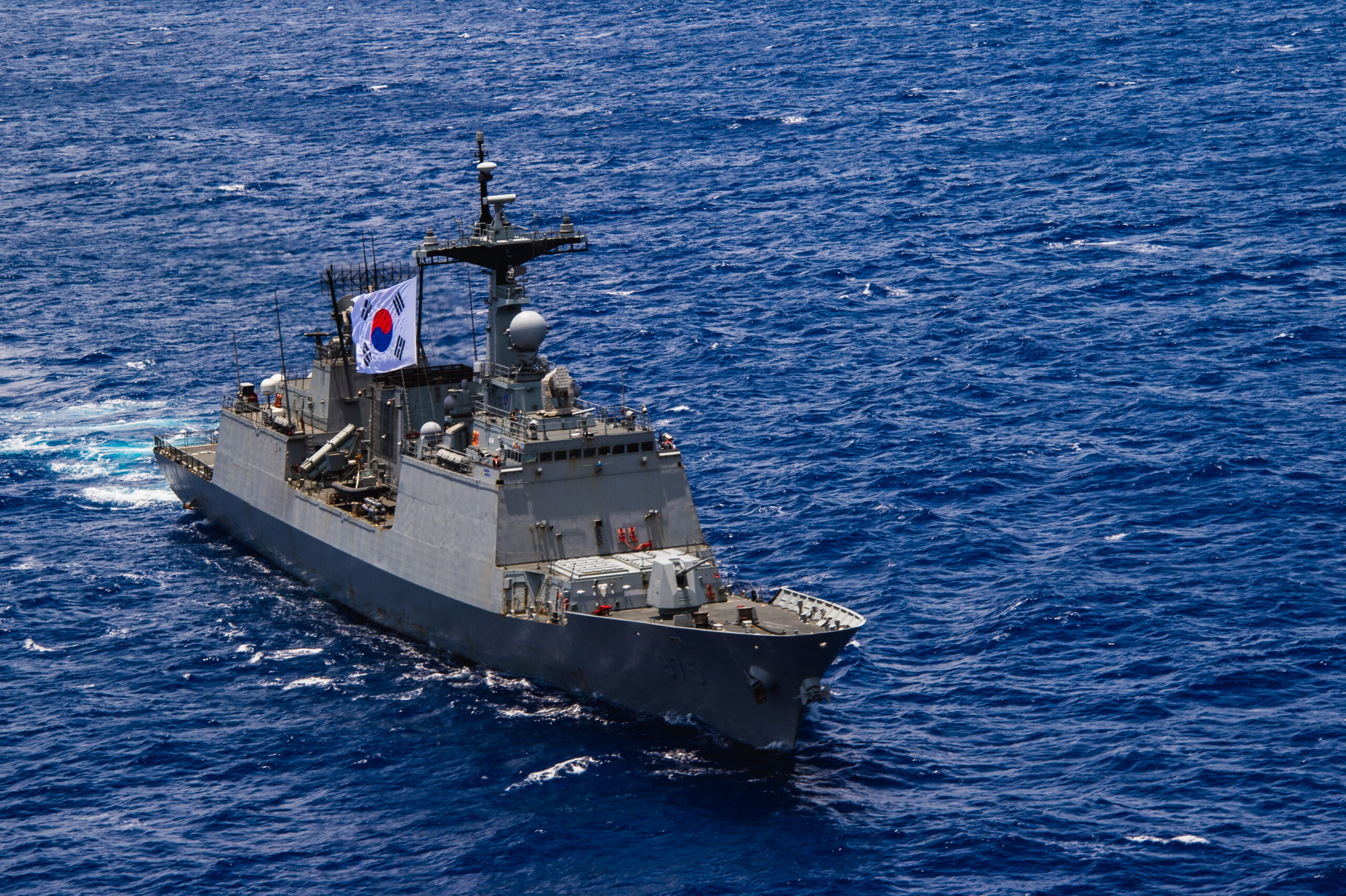 Republic of Korea navy Chungmugong Yi Sun-sin-class destroyer ROKS Chungmugong Yi Sun-sin (DDH 975) sails during the at-sea phase of Exercise Rim of the Pacific (RIMPAC) 2024. Twenty-nine nations, 40 surface ships, three submarines, 14 national land forces, more than 150 aircraft and 25,000 personnel are participating in RIMPAC in and around the Hawaiian Islands, June 27 to Aug. 1. The world’s largest international maritime exercise, RIMPAC provides a unique training opportunity while fostering and sustaining cooperative relationships among participants critical to ensuring the safety of sea lanes and security on the world’s oceans. RIMPAC 2024 is the 29th exercise in the series that began in 1971. (U.S. Navy photo by Mass Communication Specialist 2nd Class Terrin Hartman)