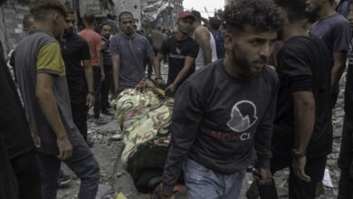 Paramedics and Palestinian people carry the bodies of people killed in Israel's attack on al-Touba (al-Tawbah) Mosque west of Jabalia Camp, north of the Gaza Strip on May 15, 2025.