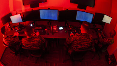 Marines with Marine Corps Forces Cyberspace Command pose for photos in cyber operations room at Lasswell Hall aboard Fort Meade, Maryland, Feb. 5, 2020. MARFORCYBER Marines conduct offensive and defensive cyber operations in support of United States Cyber Command and operate, secure and defend the Marine Corps Enterprise Network. This image is a photo illustration.