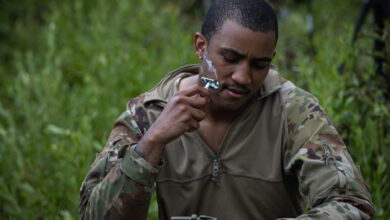 1st Lt. Jean Paul Stassi Jr., battalion IT support officer, shaves in the field before starting training, Camp Shelby, July 24, 2024. The overall focus of the unit's annual training was to instill the fundamentals and proficiency of battalion, company, and squad level operations. (U.S. Army National Guard photo by Staff Sgt. Jaccob Hearn)