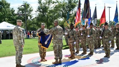 Gen. Gary M. Brito, TRADOC commanding general, and Command Sgt. Maj. Raymond S. Harris, TRADOC command sergeant major, case the TRADOC colors at the TRADOC inactivation ceremony. (US Army Photo by Jean Wines.)