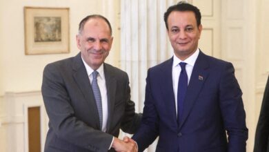 Meeting of Greece's Foreign Minister George Gerapetritis with Belgacem Haftar, son of Khalifa Haftar, while shaking hands