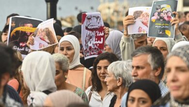 Lebanon residents holding up protest signs in the country