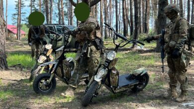 Ukrainian soldiers on Global Wolf Motors scooters