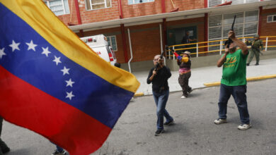 Venezuelan residents holding weapon at various training sites in the country with a flag on the left side
