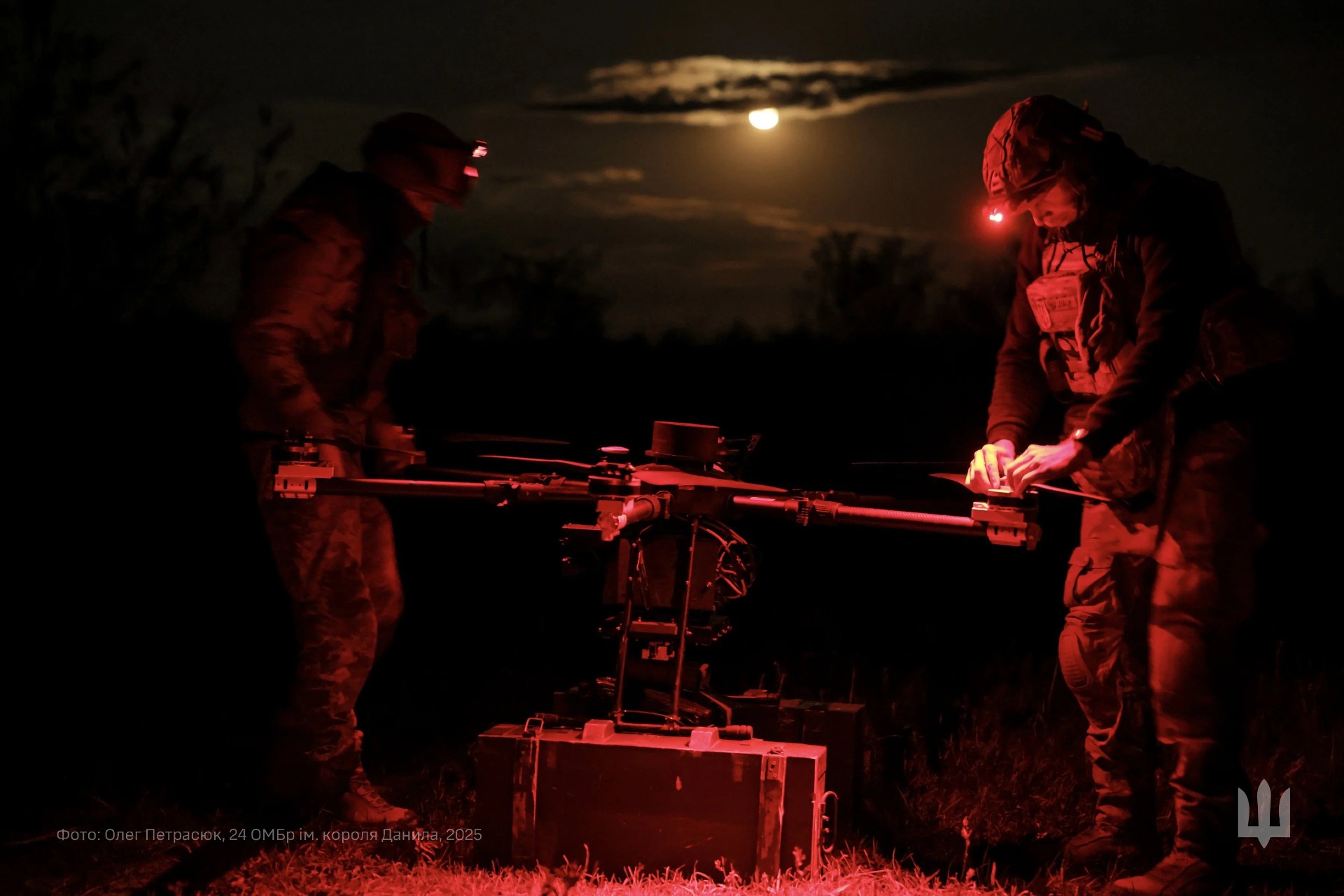 Troops setting up a drone at night