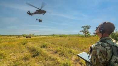 U.S. Army National Guard Sgt. uses a tablet to command the Sikorsky OPV Black Hawk to autonomously transport a 2,900-pound water buffalo sling load for the first time during Northern Strike in Michigan.